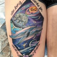 Neo traditional style colored thigh tattoo of dolphins swimming in space with lettering