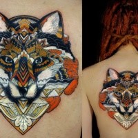 New school illustrative style back tattoo of wolf hear stylized with ornaments
