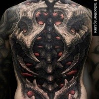 New school style awesome looking whole back tattoo of alien skeleton