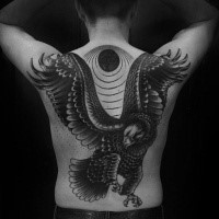 New school style black and white large eagle tattoo on back with dark sun