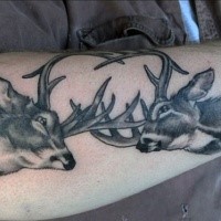 New school style black ink arm tattoo of fighting deers