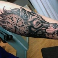 New school style colored arm tattoo of wolf head stylized with ancient ornament