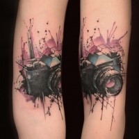 New school style colored arm tattoo of small camera