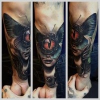 New school style colored arm tattoo of woman face stylized with butterfly and dragon eye