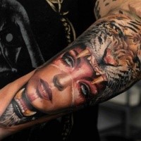 New school style colored arm tattoo of woman in tiger