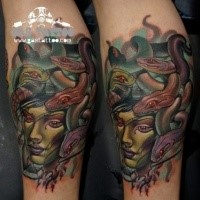 New school style colored arm tattoo of Medusa face and snakes
