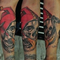 New school style colored arm tattoo of human skull with snake and red hat