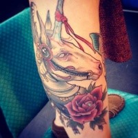 New school style colored arm tattoo of unicorn with ribbon and flowers