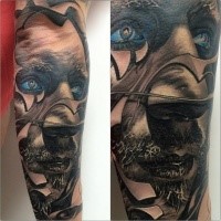 New school style colored arm tattoo of man face with blue eyes