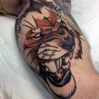 New school style colored biceps tattoo of lion with black cross