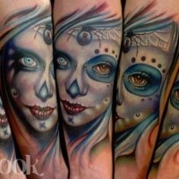 New school style colored creepy looking woman face tattoo on forearm