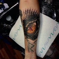 New school style colored fantasy forearm tattoo of dragon eye and lettering
