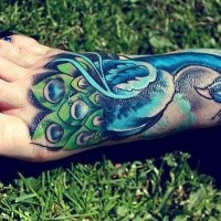 New school style colored foot tattoo of blue peacock