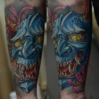 New school style colored forearm tattoo of demonic mask and flowers