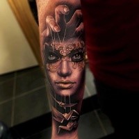 New school style colored forearm tattoo of woman with mask and paper birds