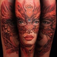 New school style colored forearm tattoo of woman with mask