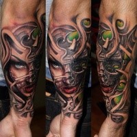 New school style colored forearm tattoo of demonic woman with skulls