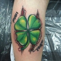 New school style colored leg tattoo of clover with lettering