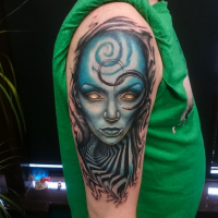 New school style colored shoulder tattoo of alien woman face