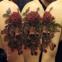 New school style colored shoulder tattoo of human skull with rose and bones