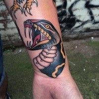 New school style colored wrist tattoo of evil snake