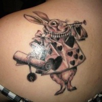 Nice 3D like colored Alice in wonderland rabbit tattoo on back