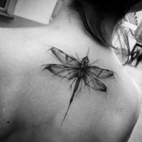 Nice black ink natural looking sketch style upper back tattoo of dragonfly
