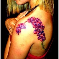 Nice branch of purple orchids tattoo on shoulder blade
