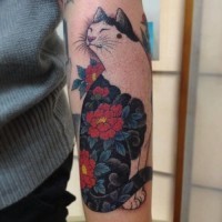 Nice cat with unusual color of red flowers forearm tattoo