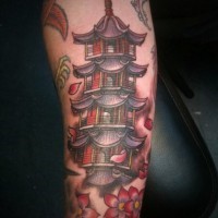 Nice colored forearm tattoo of Asian temple with flowers