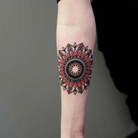 Nice colored little ornamental flower tattoo on forearm