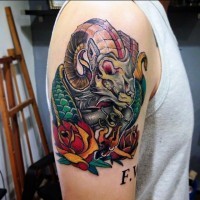 Nice colored mystical goat tattoo on shoulder with flowers