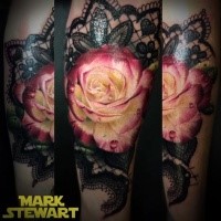 Nice combined and colored arm tattoo of cute rose with ornamental flowers