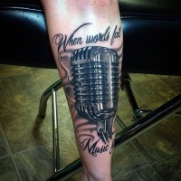 Nice designed and detailed colored vintage microphone with lettering tattoo on arm