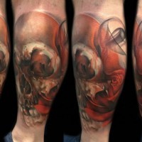 Nice designed colorful human skull with rose tattoo on leg