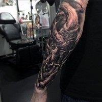 Nice detailed black and white forearm tattoo of wooden monster