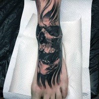 Nice detailed black ink mystical skull in fog tattoo on foot
