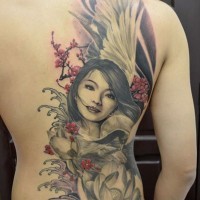 Nice girl and lotus flower tattoo on back