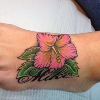 Nice hibiscus flower and name tattoo on foot