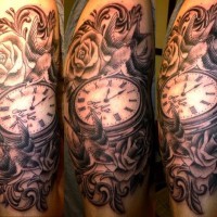 Nice looking antic old clock tattoo on shoulder with flowers and birds