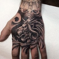 Nice looking black and white lion head tattoo on hand with crown