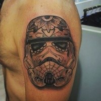 Nice looking black and white shoulder tattoo of Storm troopers helmet stylized with flowers