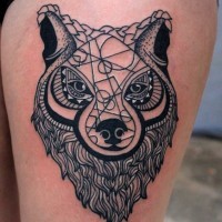 Nice looking black and white wolf tattoo on thigh stylized with geometrical ornaments