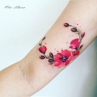 Nice looking colored arm tattoo of beautiful flowers