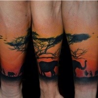 Nice looking colored forearm tattoo of desert tree with elephant