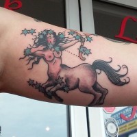 Nice looking colored seductive woman Sagittarius tattoo on arm with stars