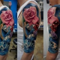 Nice looking colored shoulder tattoo of pink rose with diamonds