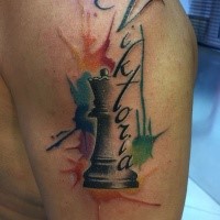 Nice looking colored shoulder tattoo of chess figure with lettering