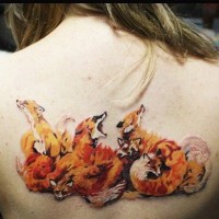 Nice looking detailed back tattoo of various foxes