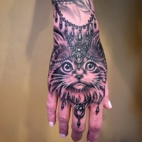 Nice looking detailed Baroque style hand tattoo of cat face
